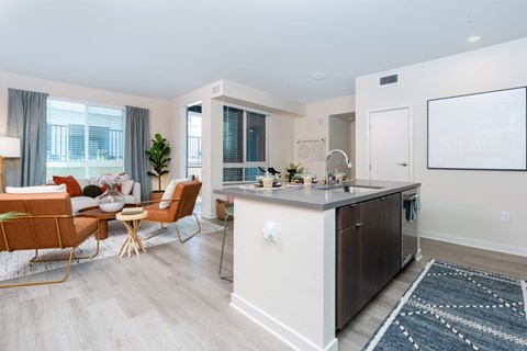 A modern kitchen with a dining table and chairs.
