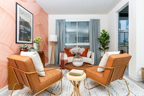 A living room with two chairs and a table.