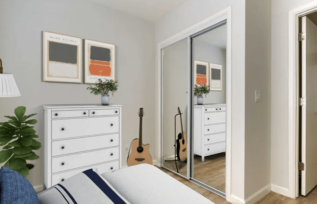 a bedroom with a bed and a mirror