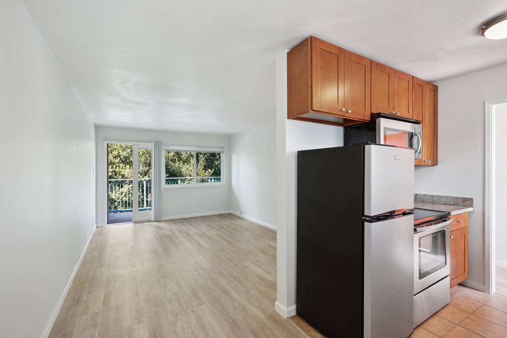 a kitchen with a refrigerator freezer and a stove top oven