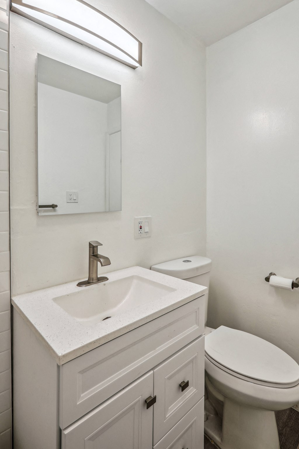 a bathroom with a sink toilet and mirror