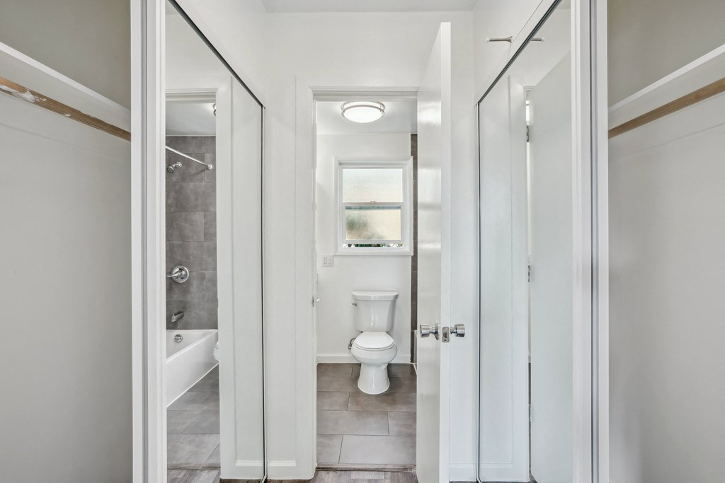 a bathroom with gray walls and a white door