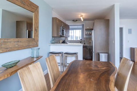 A kitchen with a wooden table and chairs.