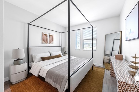 Bedroom with canopy bed frame and mirror at Ocean Creek Apartments, California, 92054