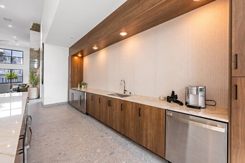 A modern kitchen with wooden cabinets and stainless steel appliances.