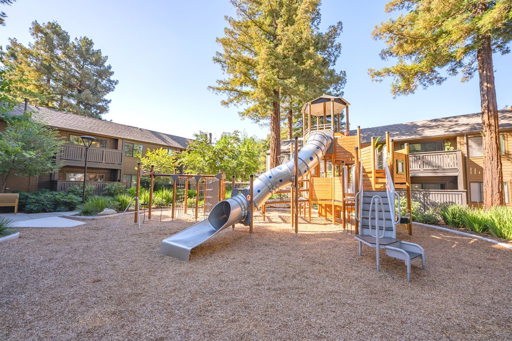 A playground with a slide and a bench.