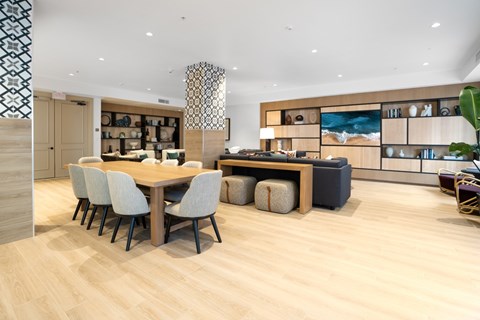 A modern dining room with a wooden table and chairs.