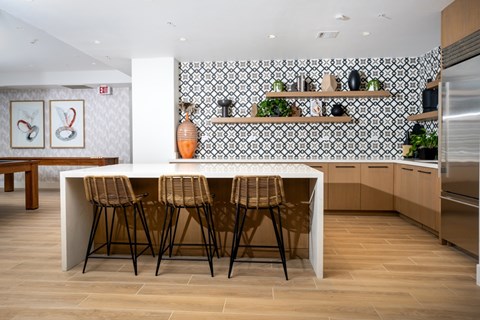 A kitchen with a white table and chairs.