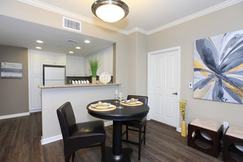 a dining room with a table and chairs and a kitchen