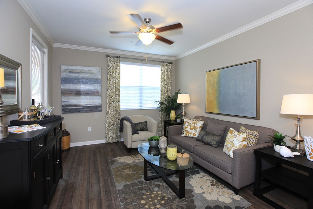 a living room with a ceiling fan and a couch