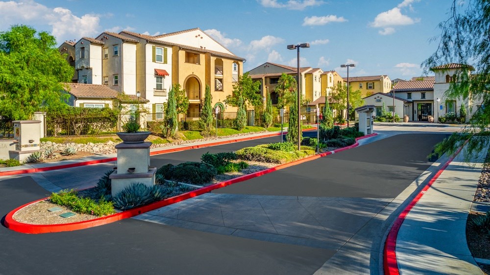 an empty street in front of an apartment building