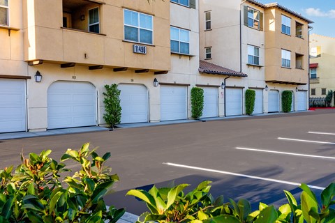 an empty parking lot in front of an apartment building