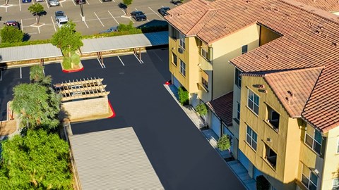an aerial view of an empty parking lot with houses