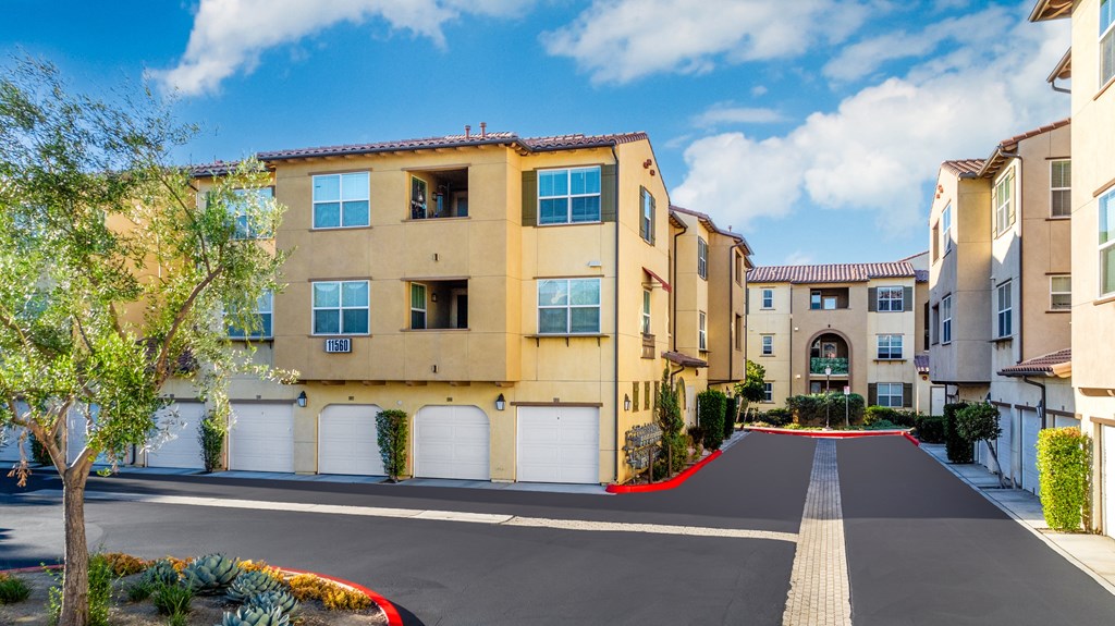 a row of apartments with white doors and a red carpet