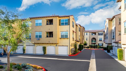 a row of apartments with white doors and a red carpet