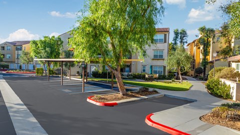 an empty parking lot in front of an apartment building