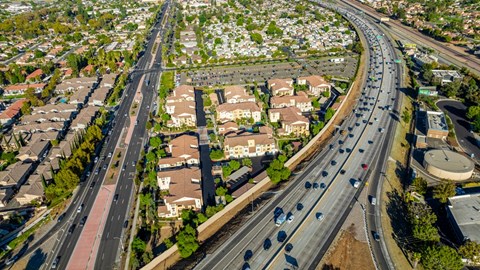 an aerial view of a city with highways and houses