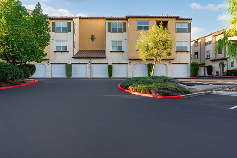 an empty parking lot in front of an apartment building