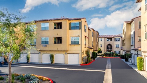a row of apartment buildings with a road in front of them