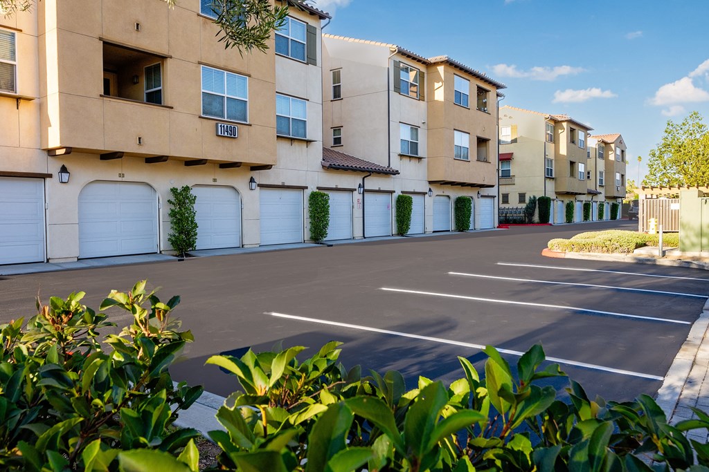 an empty parking lot in front of an apartment building