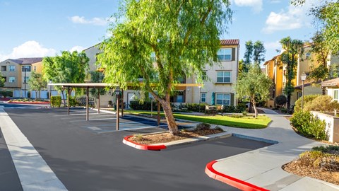 an empty parking lot in front of an apartment building