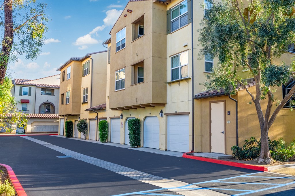 an empty street in front of an apartment building