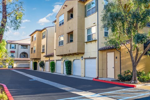 an empty street in front of an apartment building