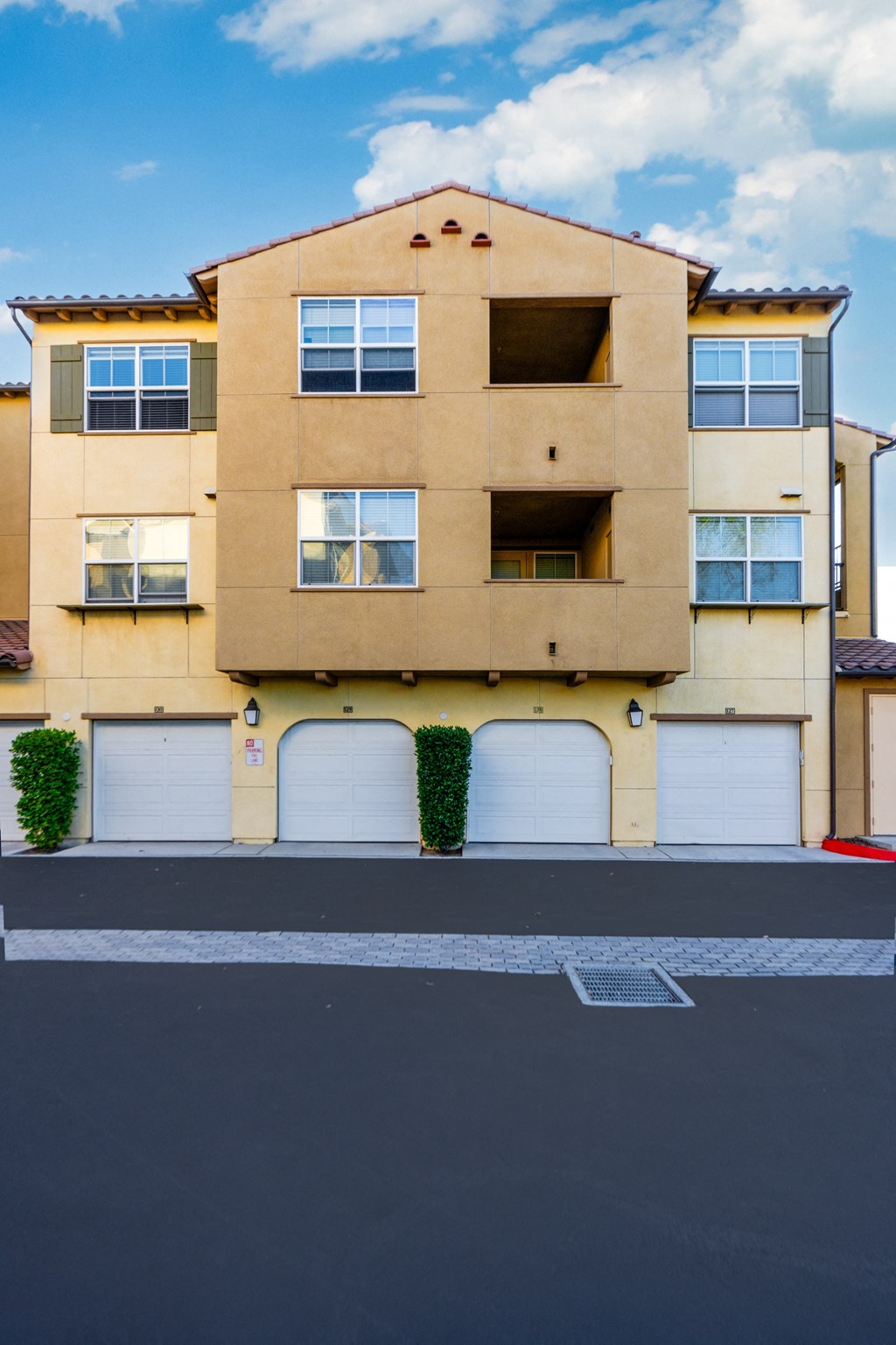 a street view of a building with garage doors