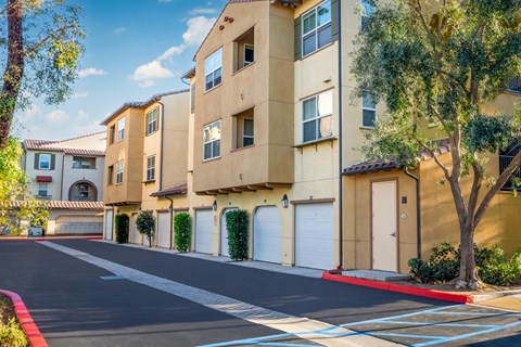 an empty parking lot in front of an apartment building