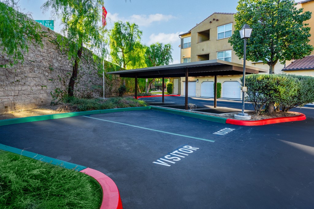 an empty parking lot with a building in the background