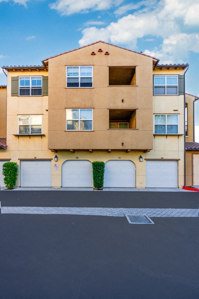 a street view of a building with garage doors