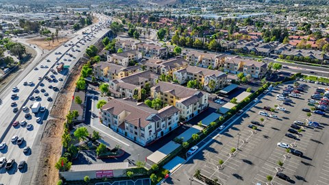 an aerial view of a city with cars on the street and buildings