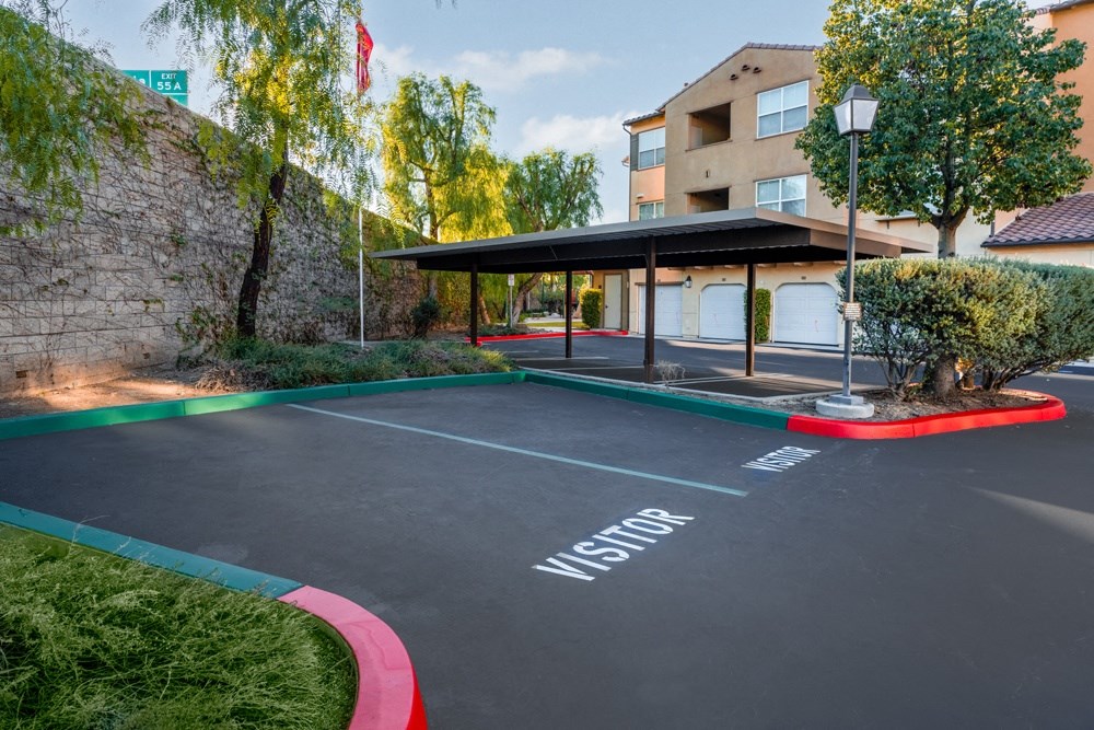 an empty parking lot with a building in the background