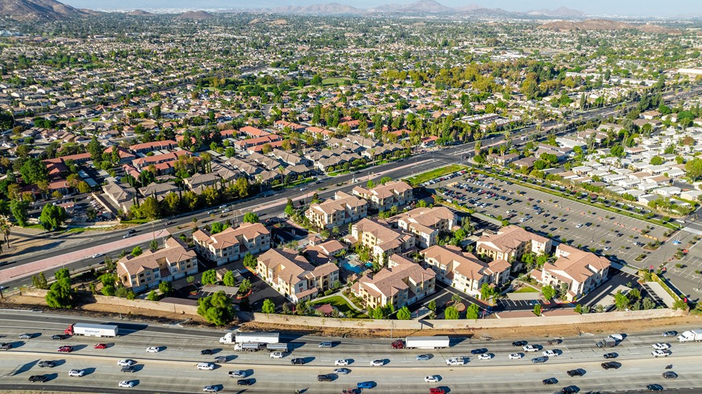 an aerial view of an intersection with cars and houses