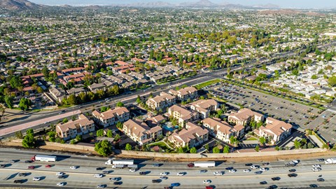 an aerial view of an intersection with cars and houses