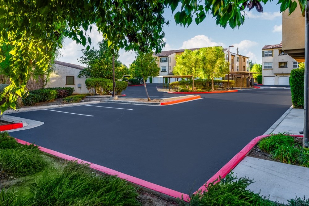 a basketball court in a neighborhood with trees and buildings