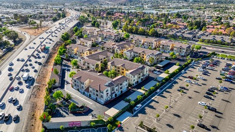 an aerial view of a city with cars on the street and buildings