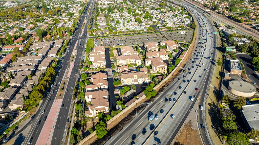 an aerial view of a suburb of a city with highways and cars