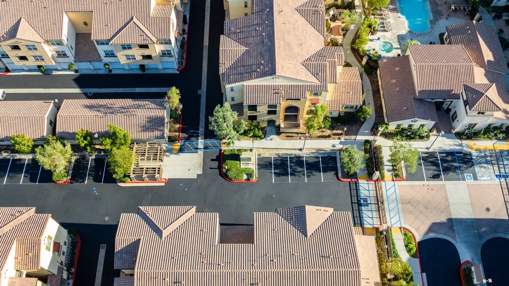 an aerial view of a neighborhood with houses and a parking lot