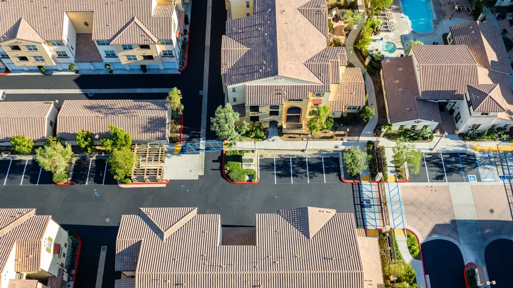 an aerial view of a neighborhood with houses and a parking lot
