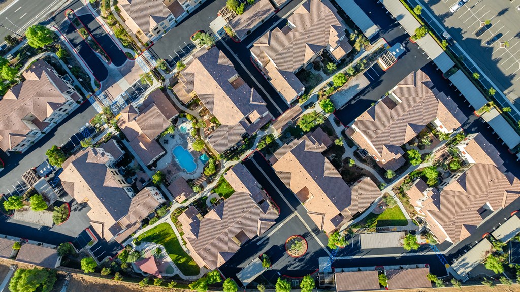 an aerial view of a suburban neighborhood with houses and cars