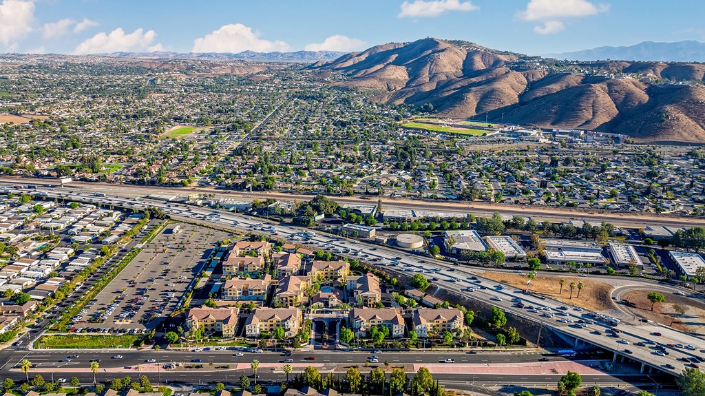 an aerial view of the city with highways and mountains