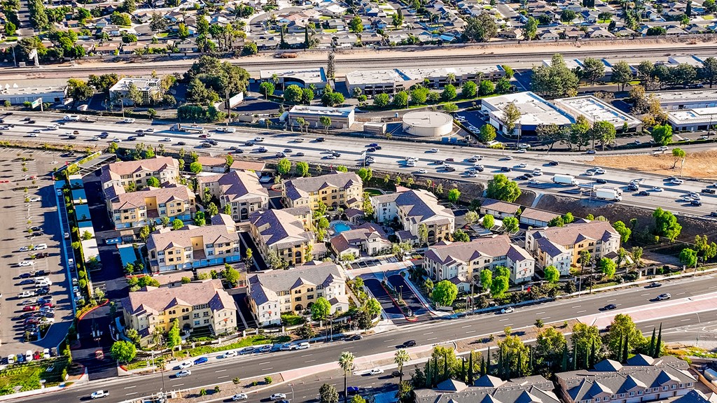 an aerial view of a suburb of a city with an intersection and parking lot