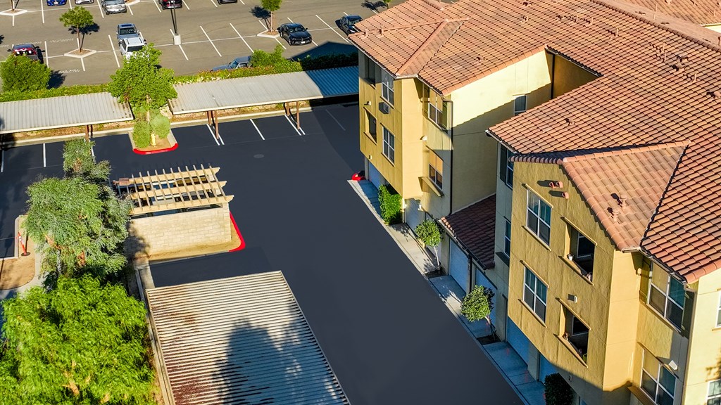 an aerial view of an empty parking lot in a residential neighborhood