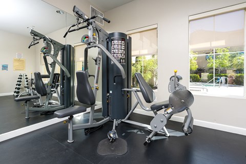 a gym with exercise equipment and a large window