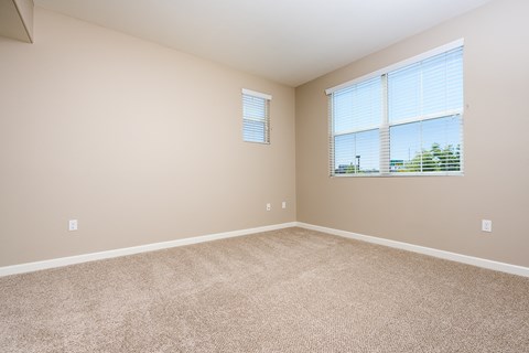 an empty bedroom with a large window