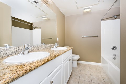 a bathroom with a toilet sink and shower