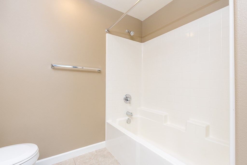 a bathroom with a tub and a toilet