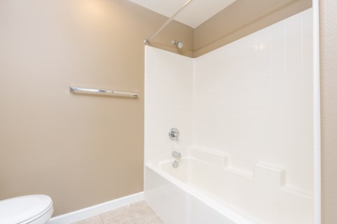 a bathroom with a tub and a toilet