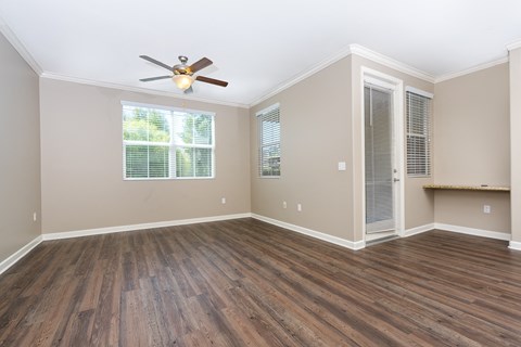 a bedroom with hardwood floors and a ceiling fan